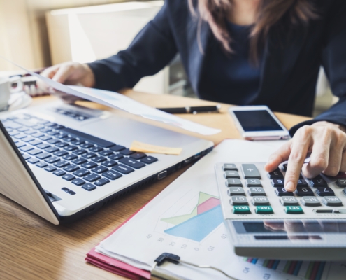 accountant working on a computer and using a calculator